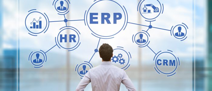IT manager analyzing the architecture of ERP (Enterprise Resource Planning) system on virtual AR screen with connections between business intelligence (BI), production, HR and CRM modules